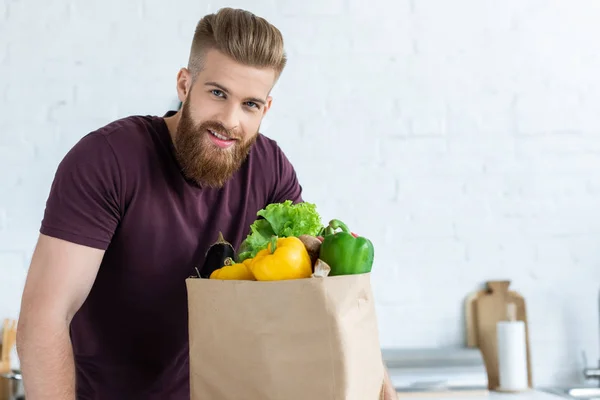Handsome Bearded Young Man Grocery Bag Smiling Camera Kitchen — Stock Photo, Image
