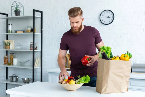 Handsome Bearded Man Putting Fresh Vegetables Bowl — Stock Photo, Image