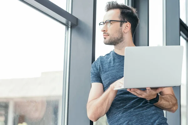 Handsome Young Man Eyeglasses Holding Laptop Looking Window — Stock Photo, Image