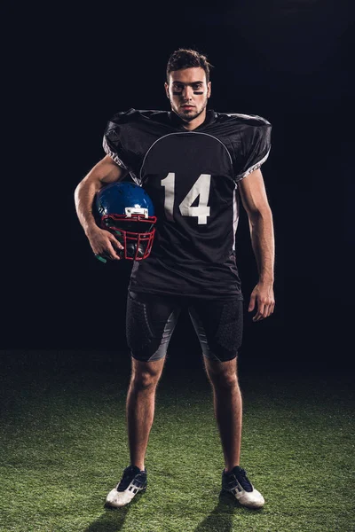 Serious American Football Player Black Uniform Holding Helmet Looking Camera — Stock Photo, Image