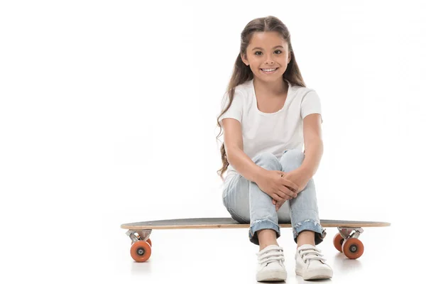 Cheerful Kid Sitting Skateboard Isolated White — Free Stock Photo