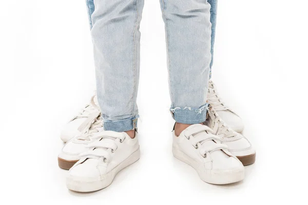 partial view of family in jeans and white footwear isolated on white