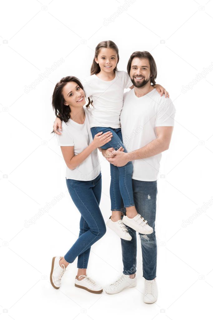 happy family in white shirts and jeans looking at camera isolated on white