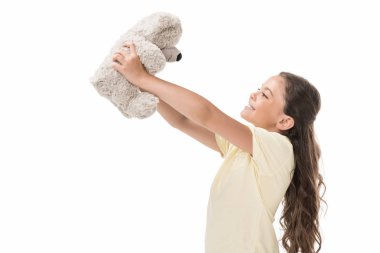 side view of cute smiling kid with teddy bear isolated on white clipart