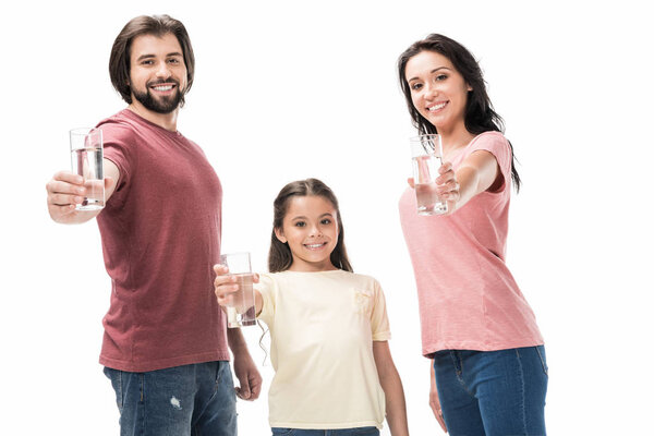 portrait of smiling family showing glasses of water in hands isolated on white