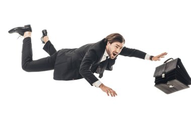 frightened young businessman falling with briefcase isolated on white clipart