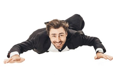 close-up shot of smiling young businessman falling and looking at camera isolated on white clipart