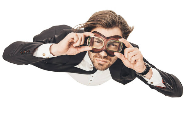 handsome young businessman in vintage aviation goggles falling isolated on white