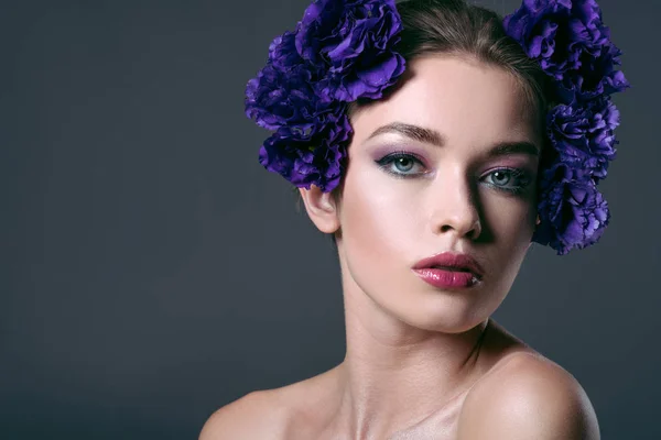 Close-up portrait of beautiful young woman with eustoma flowers on head looking at camera isolated on grey — Stock Image Close Portrait Beautiful Young Woman Eustoma Flowers Head Looking Camera Royalty Free Stock Images