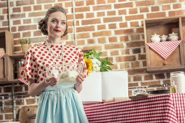 Beautiful Adult Housewife Holding Bowl Dough Looking Away Kitchen — Free Stock Photo