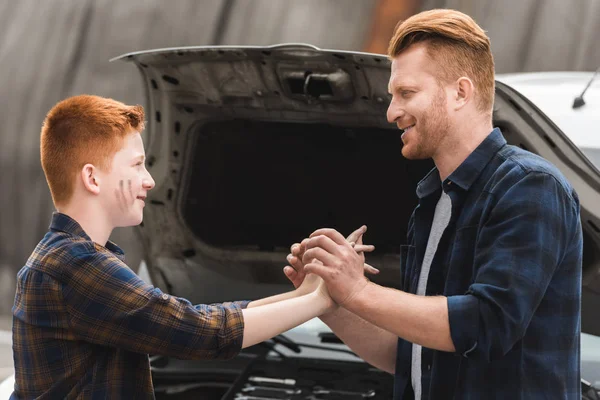 Father Son Holding Hands Repairing Car — Free Stock Photo