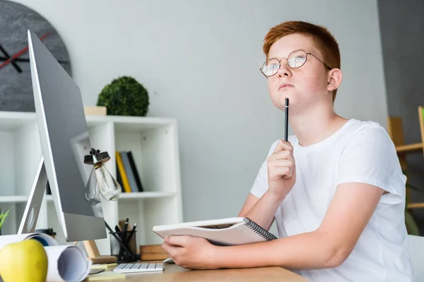 Pensive Preteen Boy Holding Pen Notebook Table Home — Stock Photo, Image