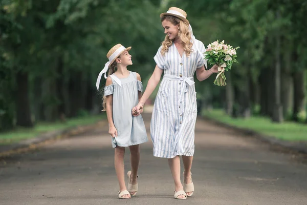 Madre Hija Sombreros Paja Tomados Mano Caminando Parque Verde — Foto de Stock