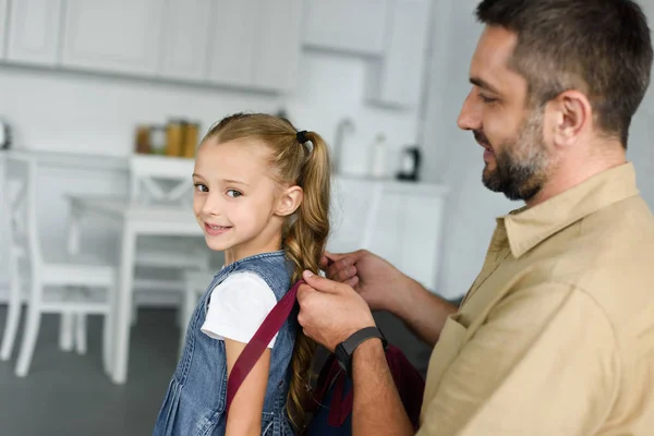 Side View Father Helping Daughter Wear Backpack Home Back School — Stock Photo, Image