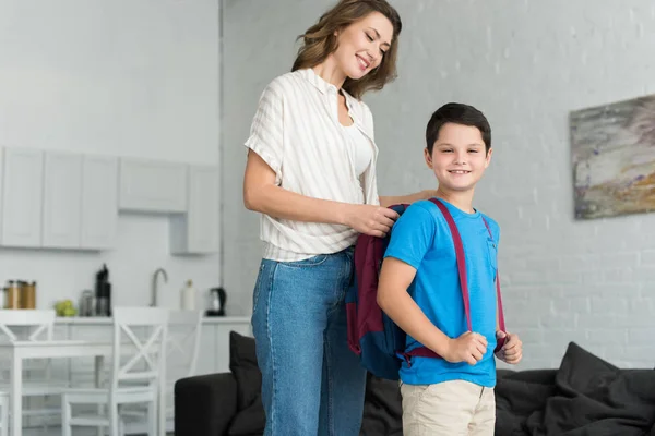 Smiling Mother Helping Son Wear Backpack Home Back School Concept — Stock Photo, Image