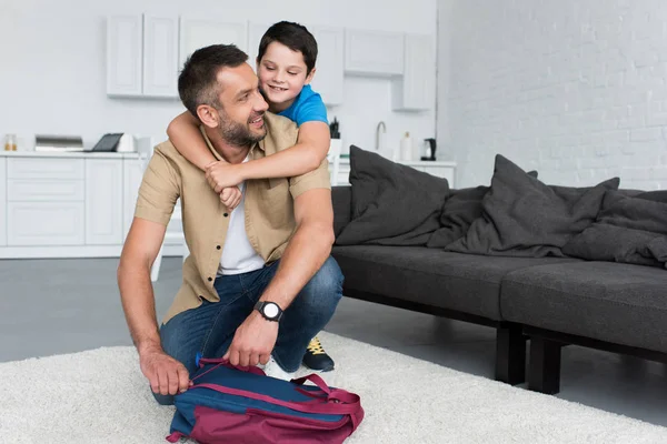 Happy Son Hugging Father Backpack Floor Home — Stock Photo, Image