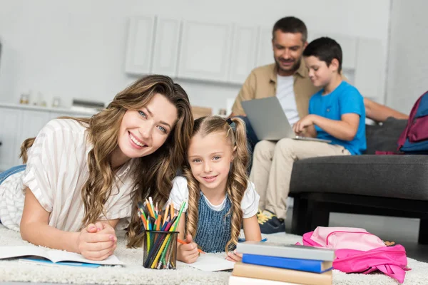 Selective Focus Smiling Mother Daughter Doing Homework While Father Son — Stock Photo, Image
