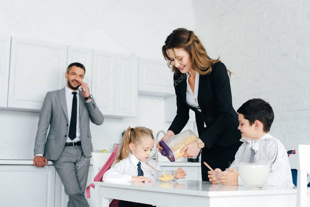 family having breakfast in kitchen at home on first school day