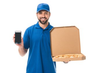 handsome delivery man holding smartphone and pizza in box isolated on white   clipart