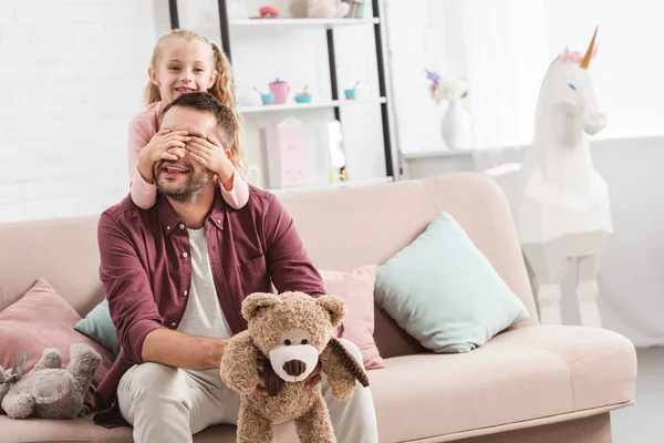 Daughter Closing Father Eyes Sofa Home — Stock Photo, Image