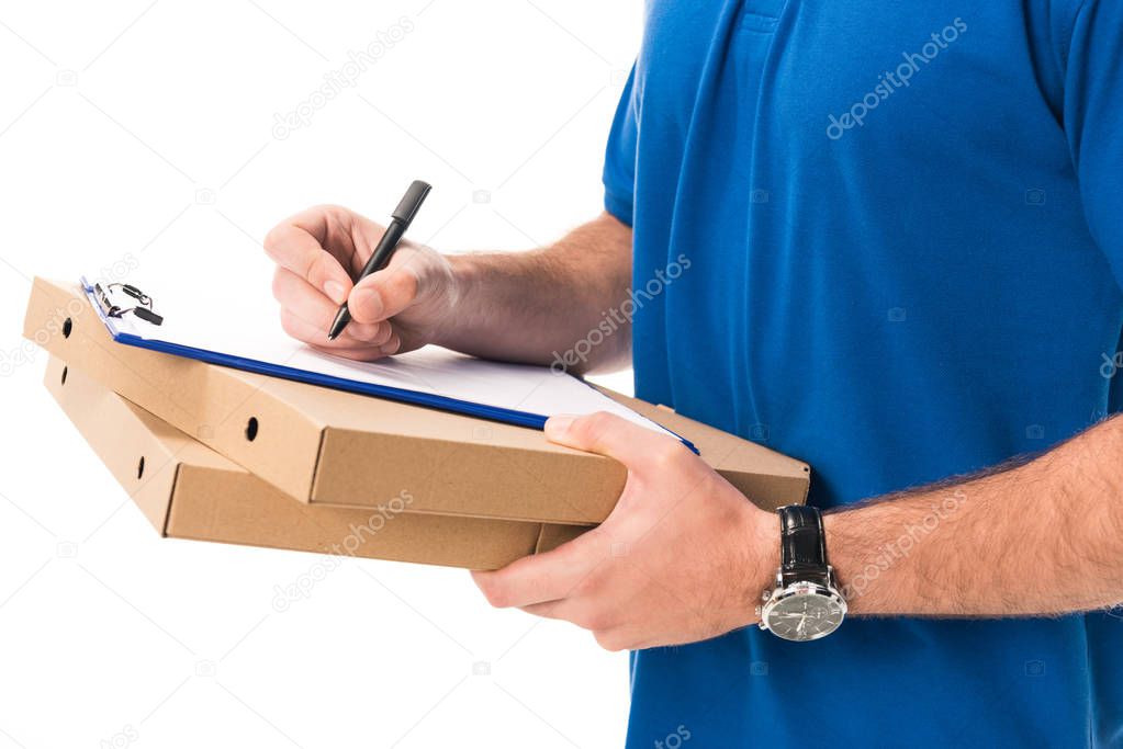 cropped shot of delivery man holding boxes with pizza writing on clipboard isolated on white 