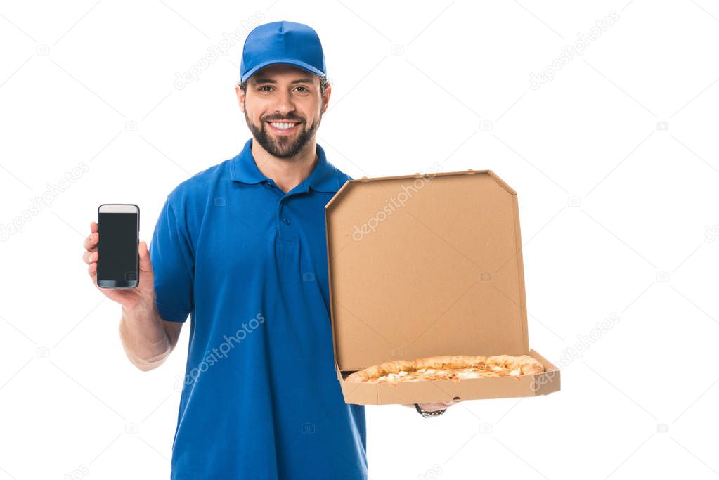 handsome delivery man holding smartphone and pizza in box isolated on white  