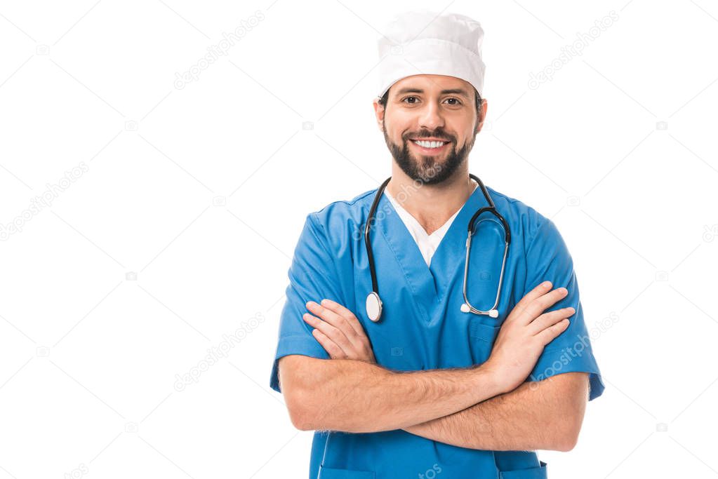 handsome bearded surgeon standing with crossed arms and smiling at camera isolated on white 