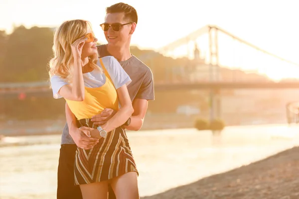 Boyfriend Cuddling Girlfriend River Beach Sunset She Touching Sunglasses — Free Stock Photo