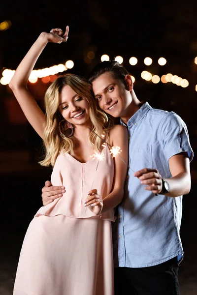 Happy Young Couple Dancing Holding Party Sparkles River Beach Evening — Stock Photo, Image