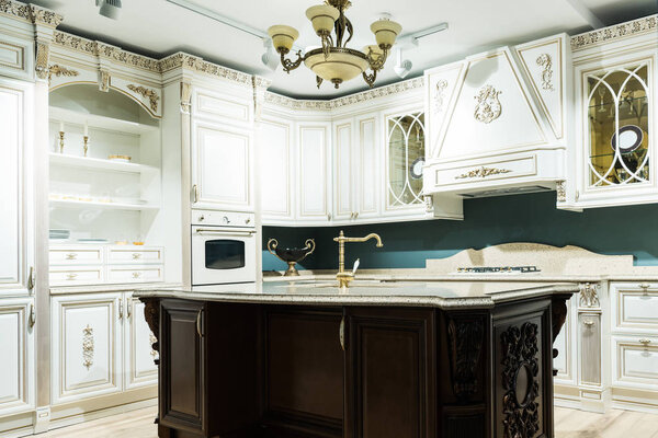 interior of modern kitchen with comfortable wooden furniture in baroque style