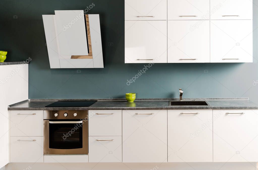 interior of modern kitchen with white kitchen counter, stove and oven