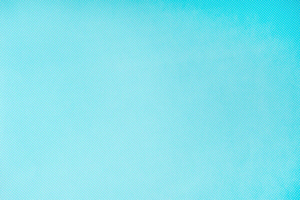 top view of white polka dots on turquoise background