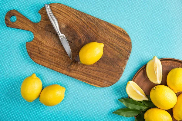 Top View Yellow Lemons Knife Wooden Cutting Board Turquoise Background — Stock Photo, Image