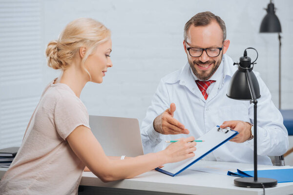 female patient having appointment with chiropractic in clinic