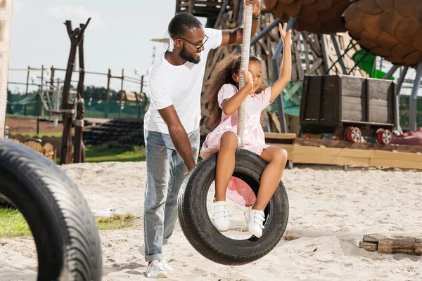 African American Daughter Showing Two Fingers Tire Swing Amusement Park — Stock Photo, Image