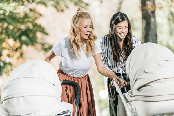 Laughing Mothers Looking Baby Stroller Park — Stock Photo, Image