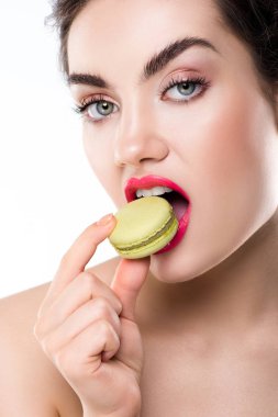 attractive stylish woman biting green macaron, isolated on white clipart
