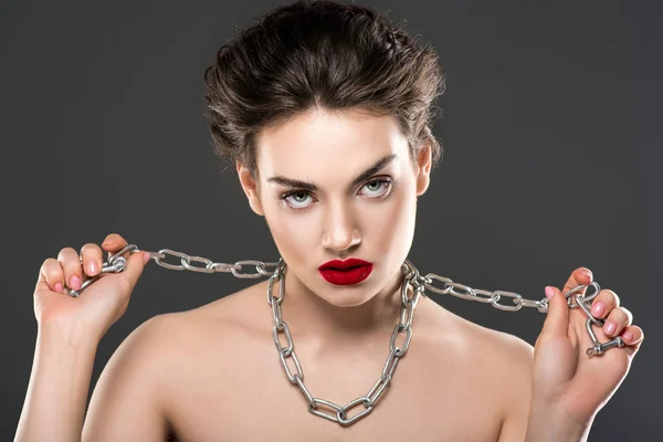 young naked woman with chain on neck, isolated on grey