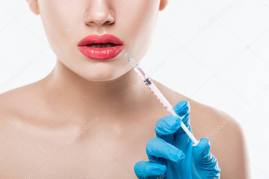 cropped view of woman making beauty injection in lips, isolated on white