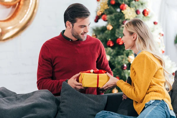 Feliz Pareja Regalando Regalo Casa Con Árbol Navidad —  Fotos de Stock