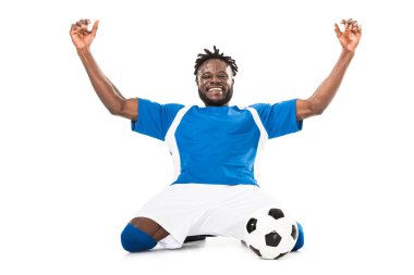 excited african american soccer player triumphing and raising hands isolated on white clipart