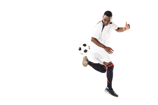 full length view of athletic african american soccer player kicking ball isolated on white 