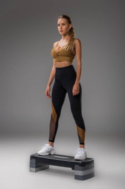 çekici genç kadın Grey Step Aerobik yapıyor