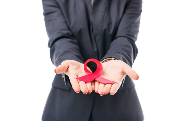cropped shot of businesswoman holding aids awareness red ribbon symbol isolated on white