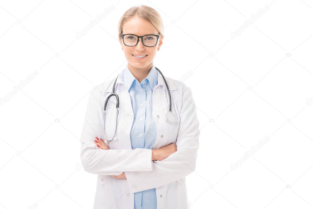 confident young female doctor with crossed arms looking at cameraisolated on white