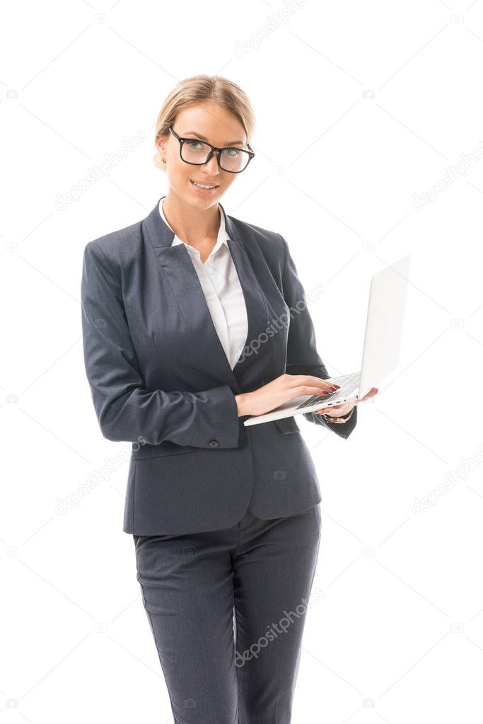 beautiful young businesswoman working with laptop isolated on white