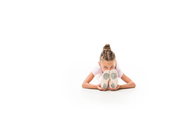 focused child stretching isolated on white background 