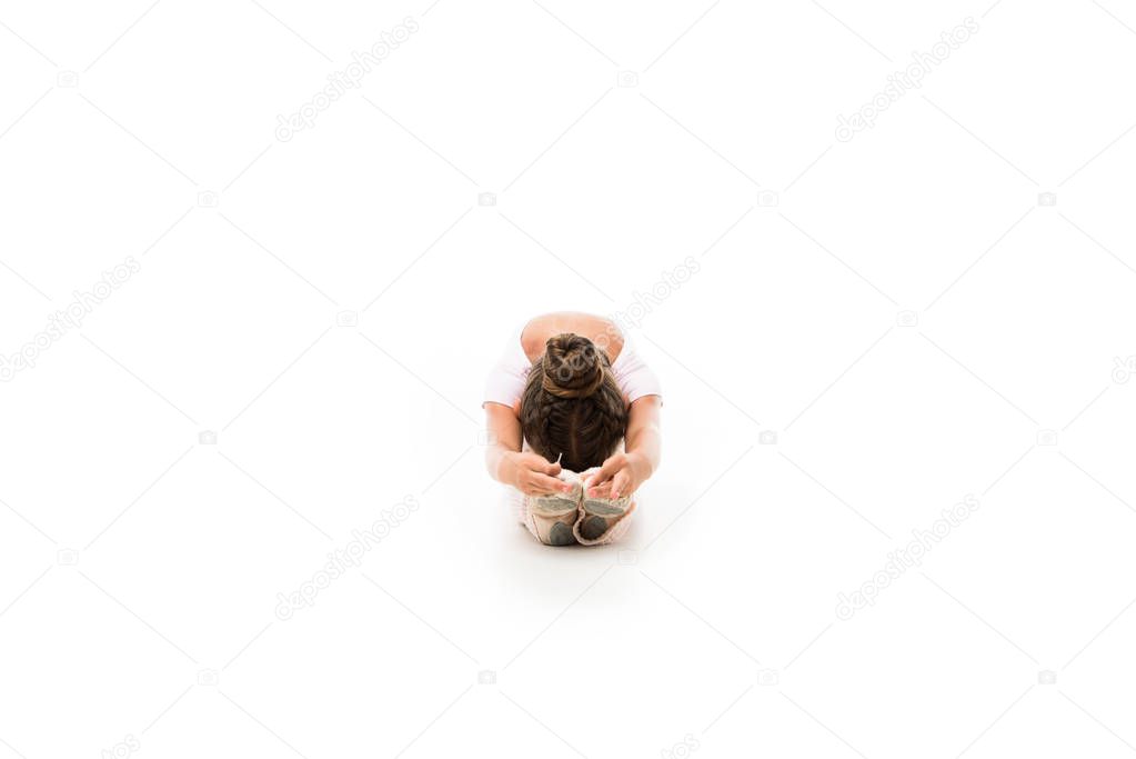 little ballerina stretching isolated on white background 