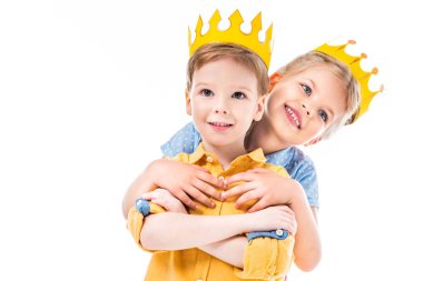 sister hugging brother, kids in yellow paper crowns, isolated on white  clipart