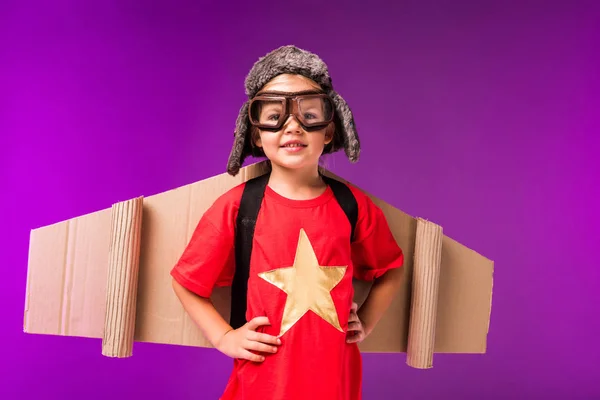 Happy Child Paper Plane Wings Hat Protective Goggles Isolated Purple — Stock Photo, Image